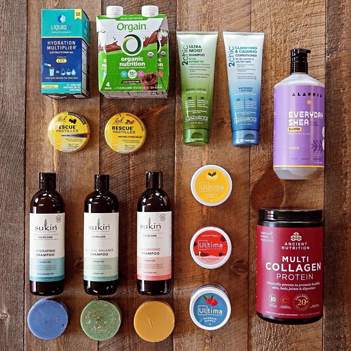 Various health and beauty products arranged on a wooden surface, including shampoos and supplements.