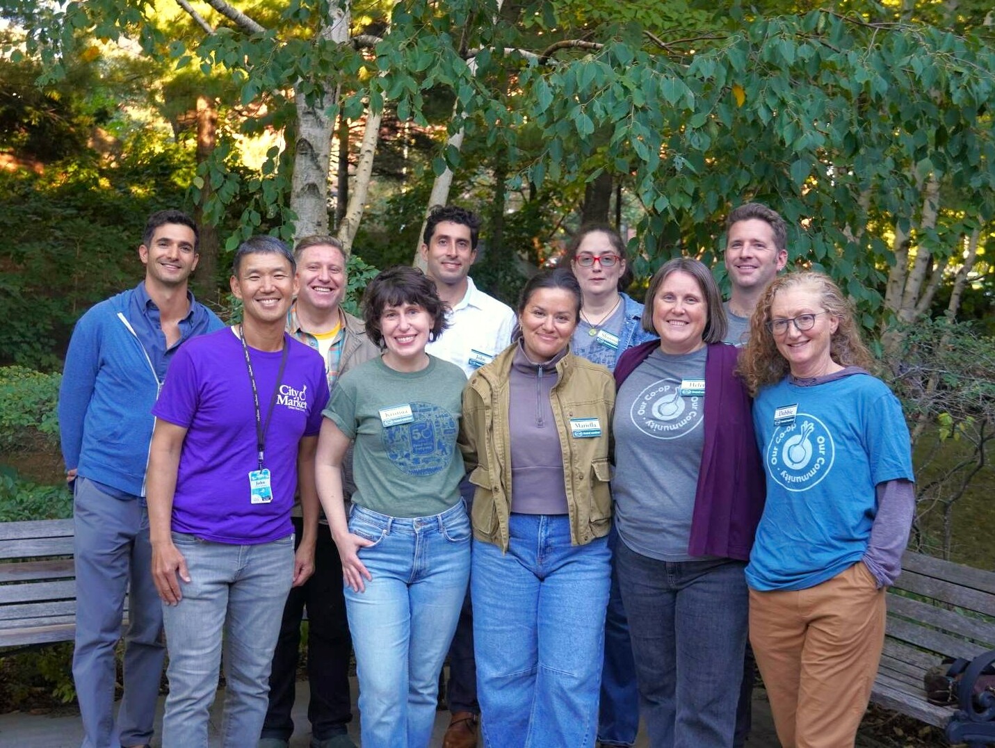 10 adults stand outside for a picture