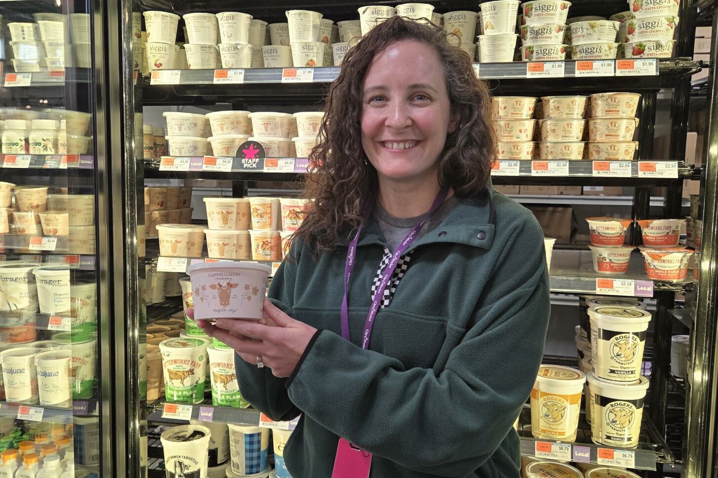 a woman holding up yogurt