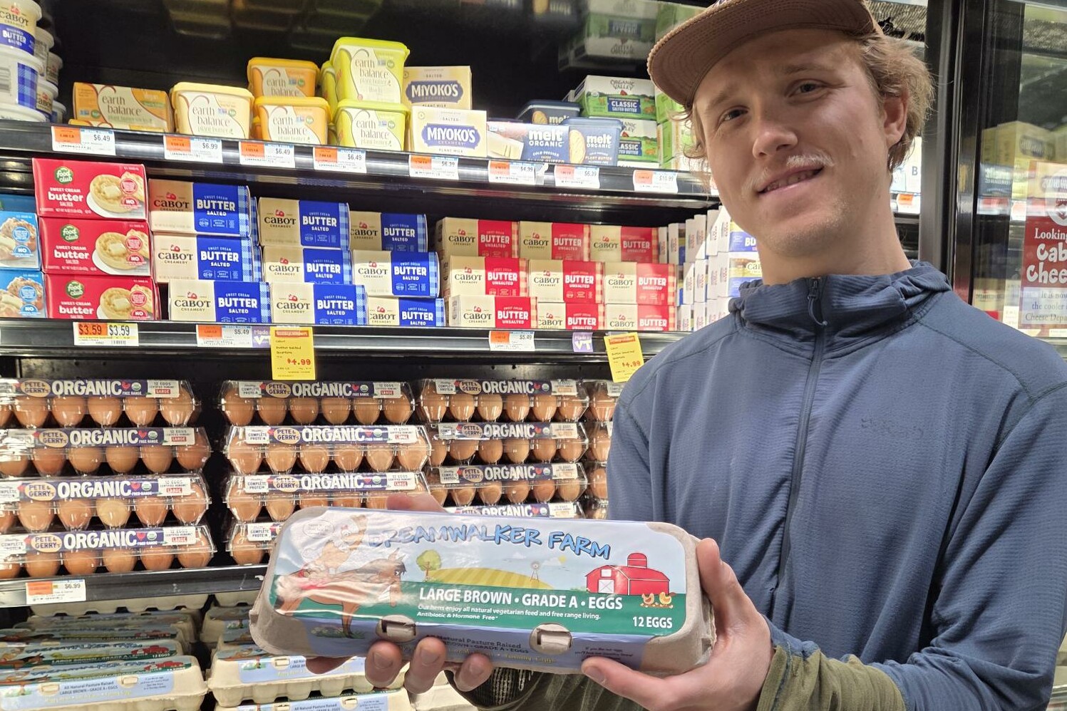 a man holds up a carton of eggs