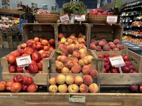 Peaches displayed in wooden crates