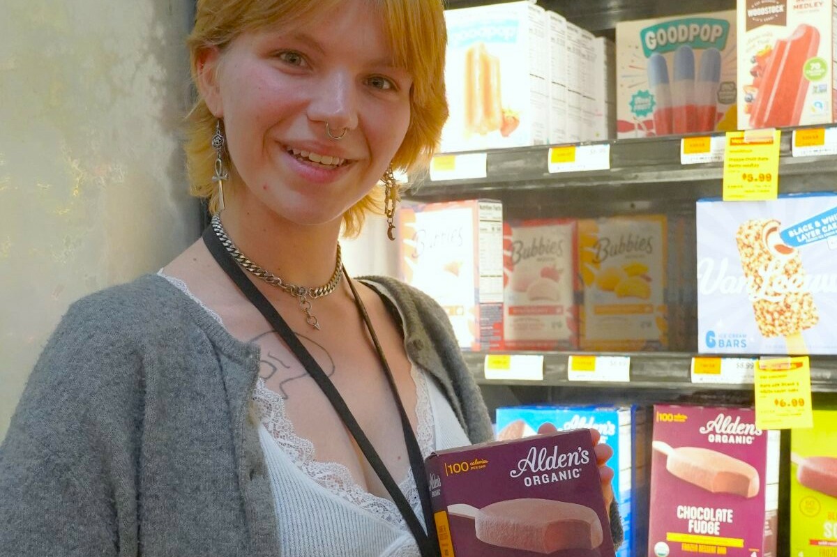 A woman holds up a box of ice cream