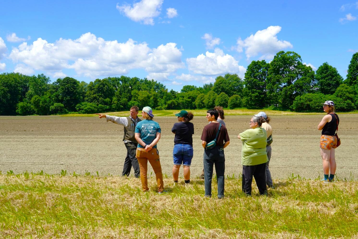 people standing in a field outside