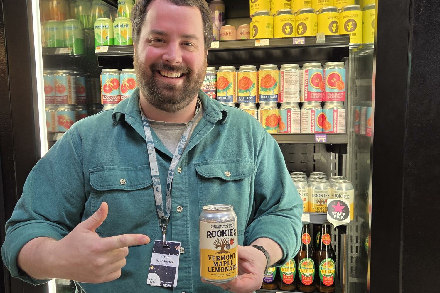 a man holding up a an of lemonade