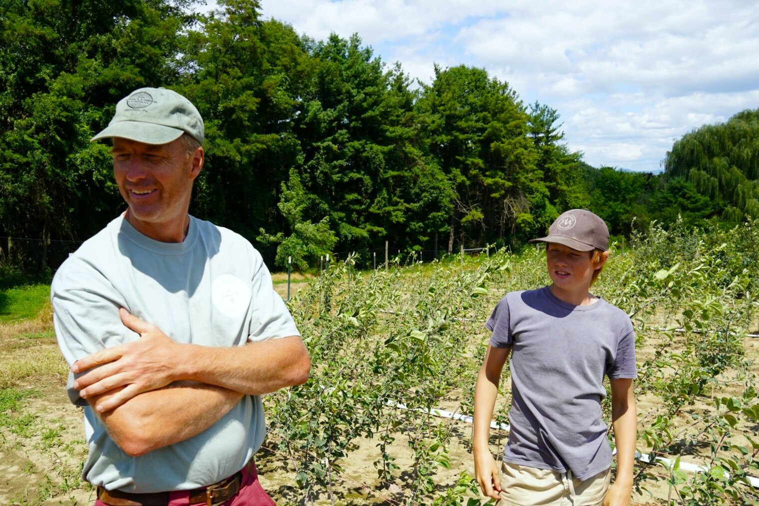 a man and his son standing at a farm