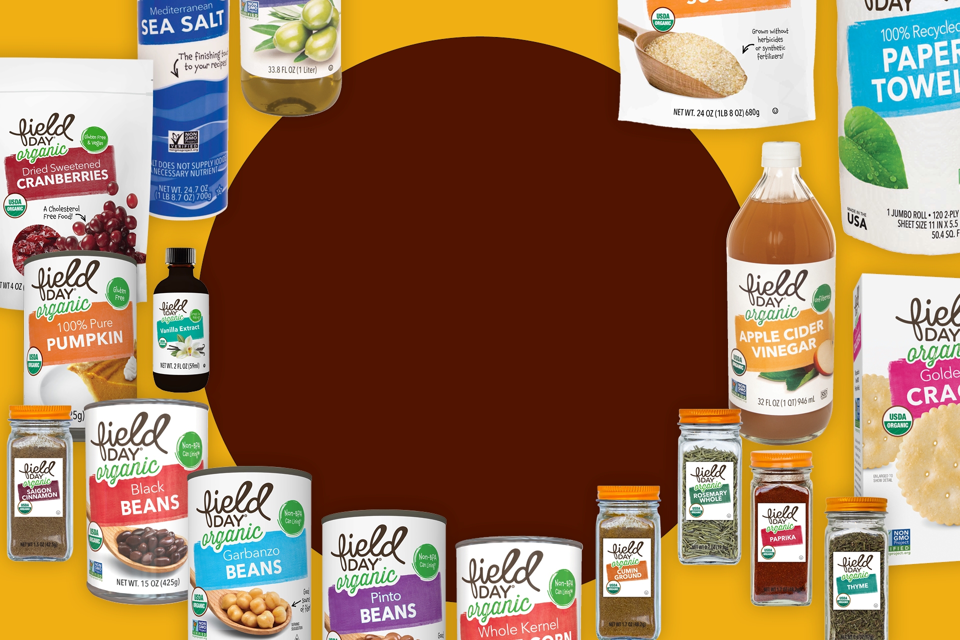 Lots of grocery products from the Field Day brand are scattered across a yellow and rust red background. 