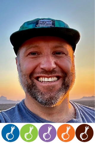 A photo of a man from the shoulders up. He is wearing a blue tee shirt and a teal trucker hat. He has a short, gray-tinged beard. He is smiling. Below the photo, five silhouettes of onions are arranged inside five colored circles in a horizontal line. In order from left to right, the circles are blue, green, purple, orange and brown.